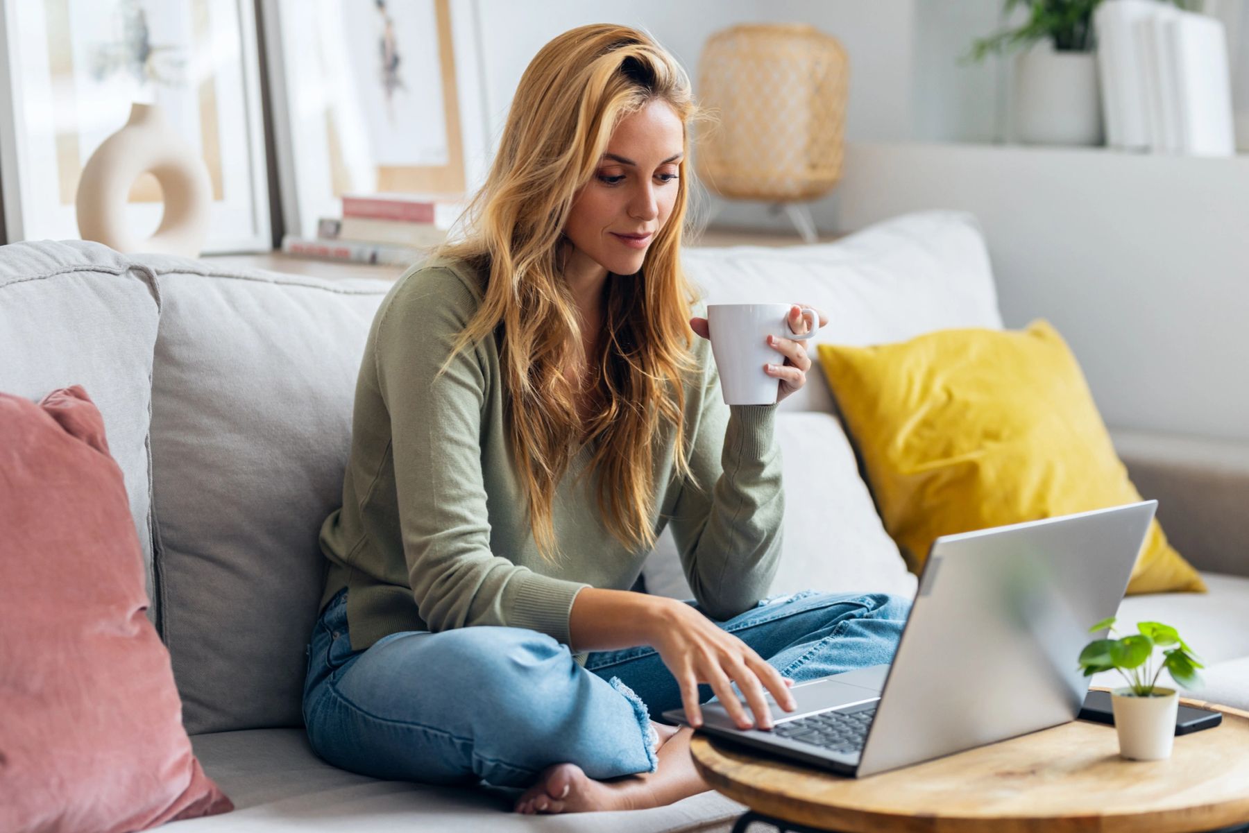 Woman working on her laptop with a cup of coffee